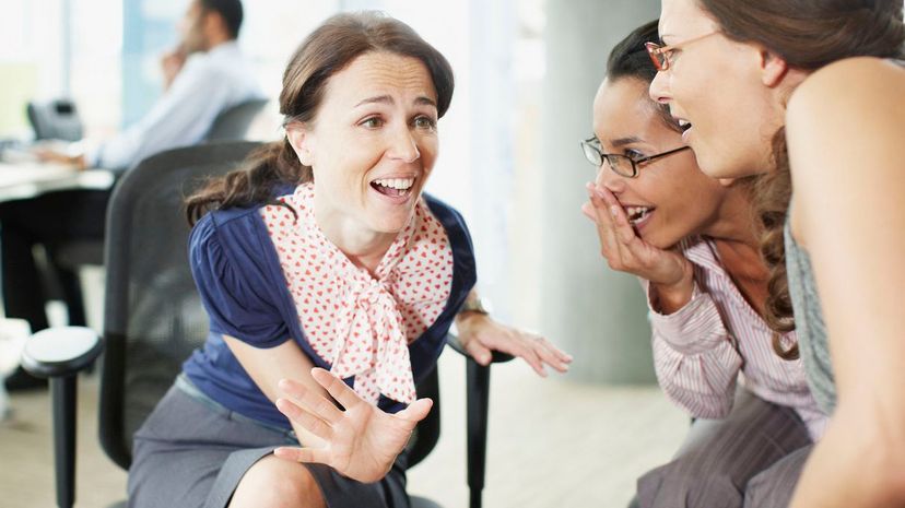 Businesswomen gossiping in office