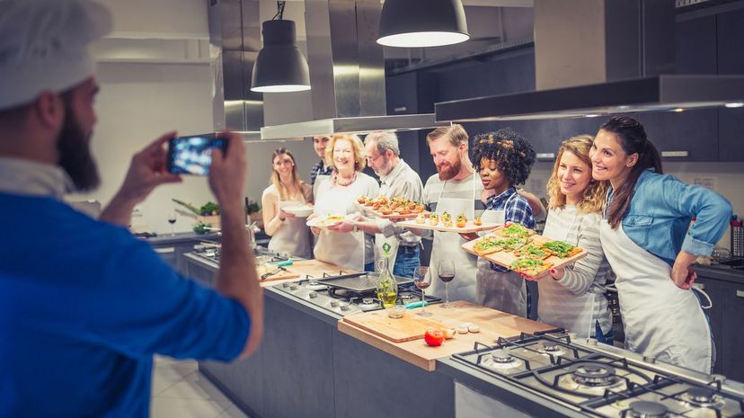 Chef is photographing attendees of cooking class