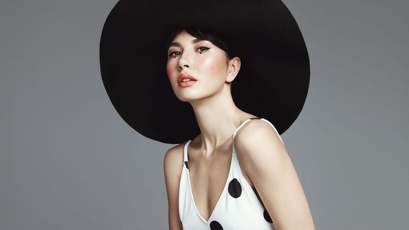 Beautiful elegant woman with oversized hat