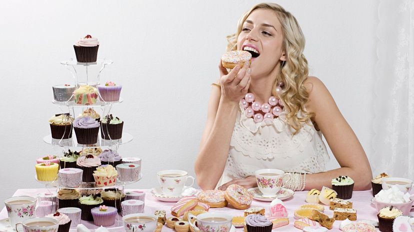 Woman eating cupcakes