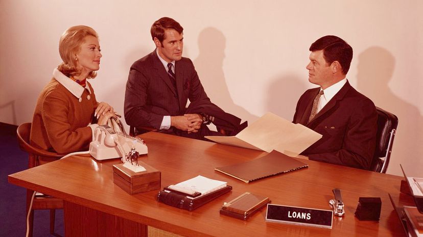 1970s Couple Talking to Banker