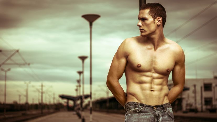 handsome shirtless man urban backdrop