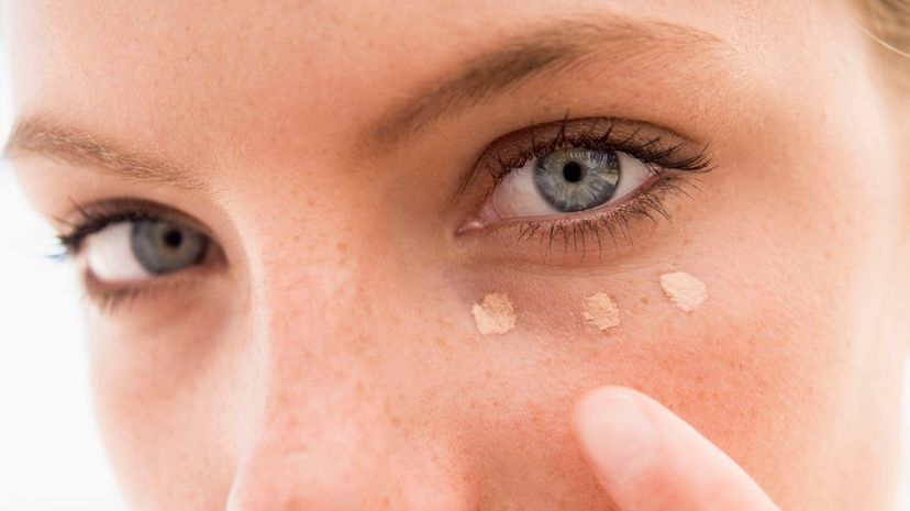Woman applying concealer