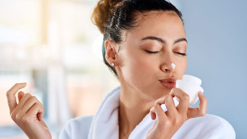 Woman applying skincare product