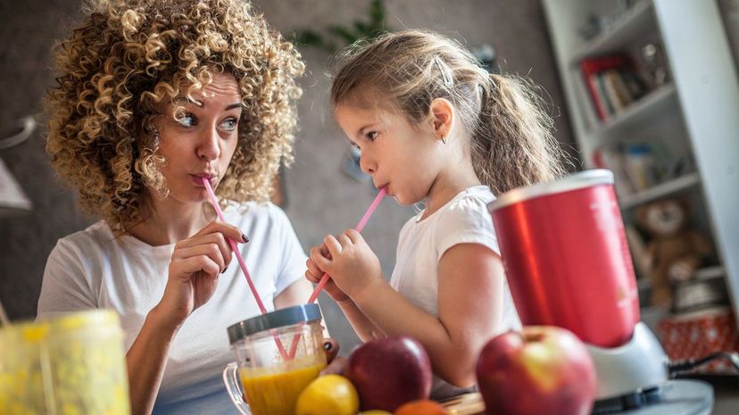 Mother and daughter making smoothie