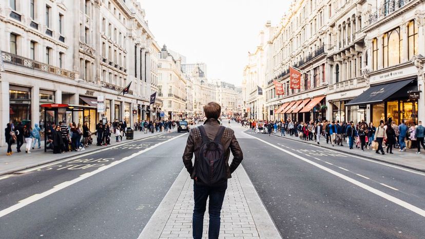 Rear view of a man with backpack exploring street of London, England, UK