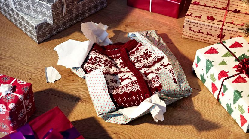Unwrapped christmas jumper and gifts