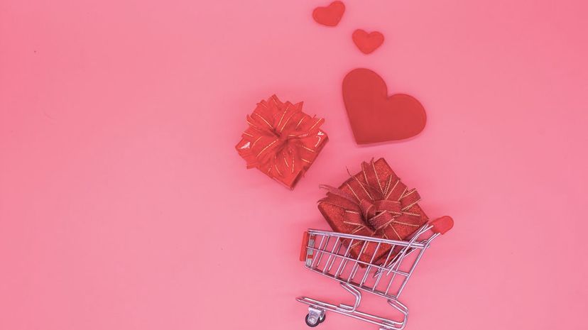 shopping trolley with gift box concept, love hearts Valentine's Day on background