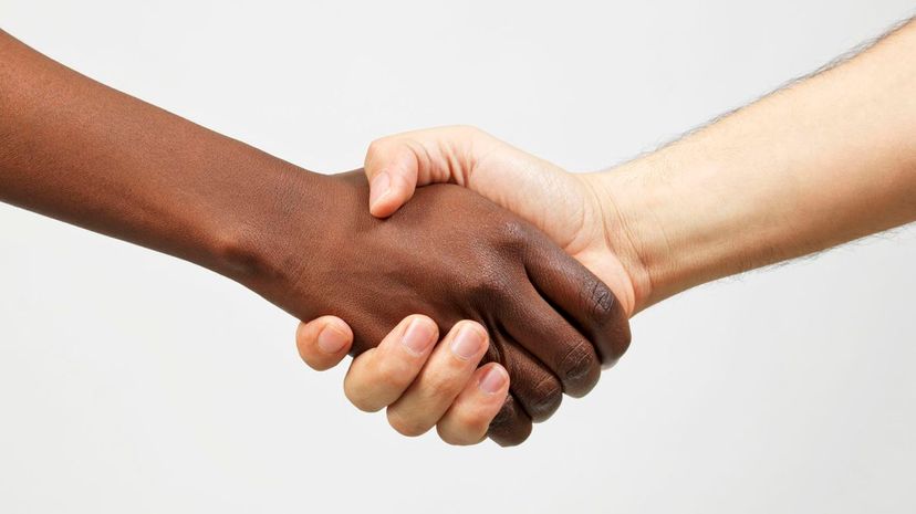 Black woman and caucasian man shaking hands