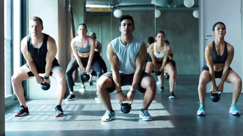 Working out with kettle bells in a gym