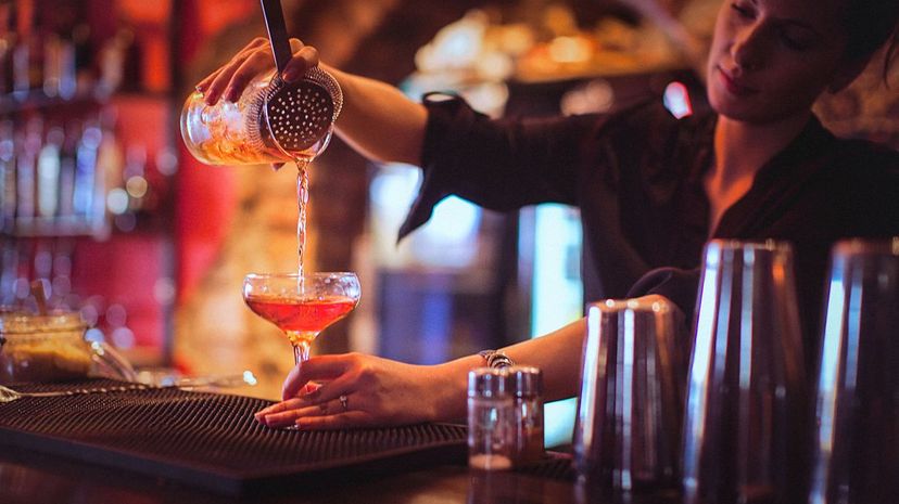 Female Bartender Mixing Cocktail