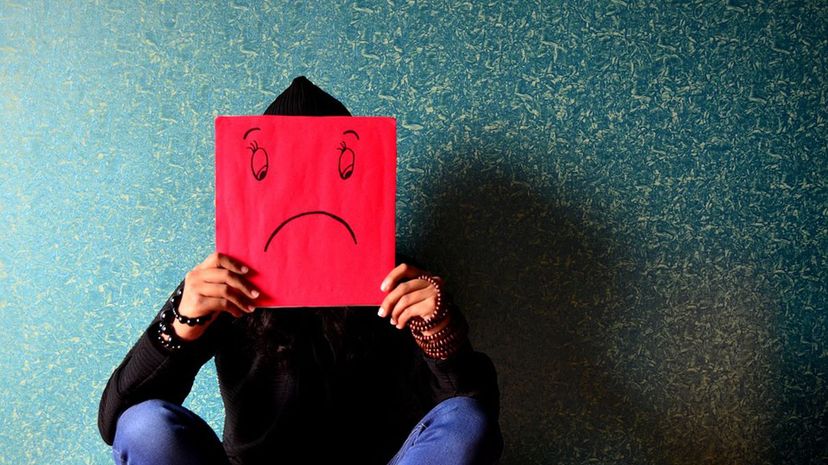 Person Holding Sad Sign