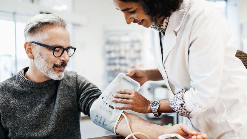 Pharmacist Measuring Mature Man's Blood Pressure