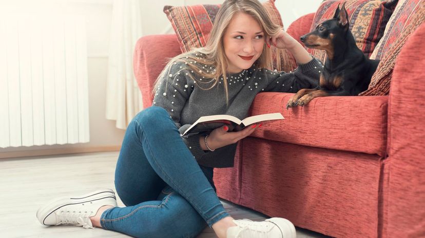 Woman reading with dog