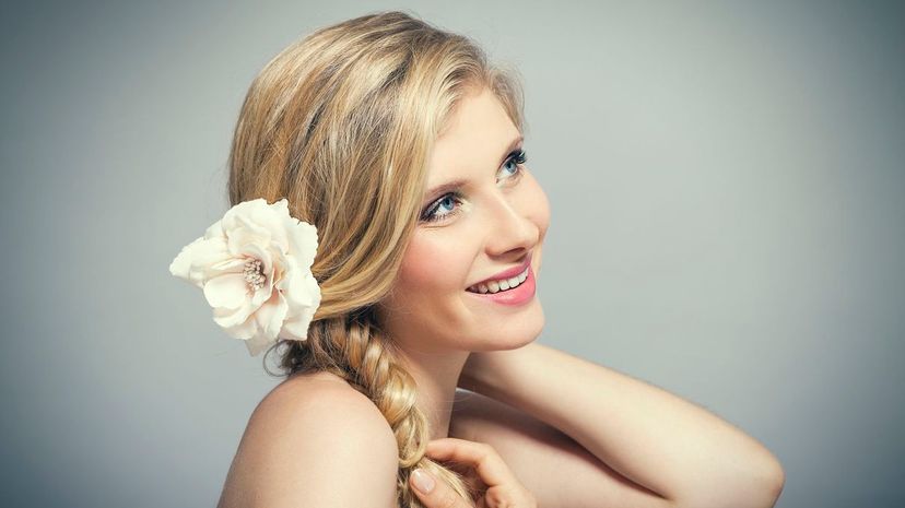 Smiling Young Woman Wearing Flower in Blond Hair