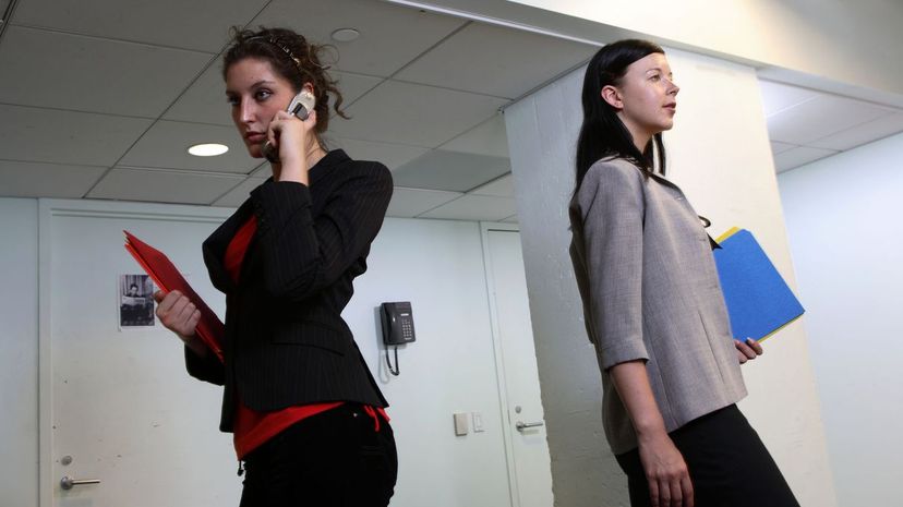 Business women walking back to back