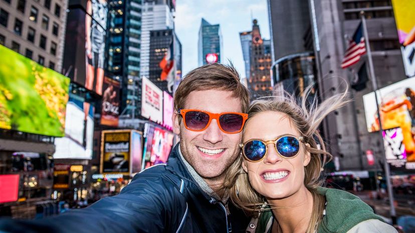 Couple taking selfie in Times Square, New York