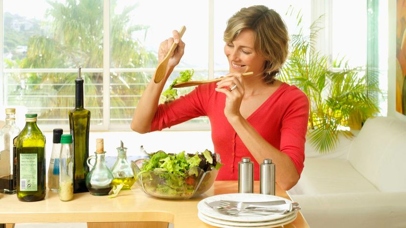 Woman tossing salad