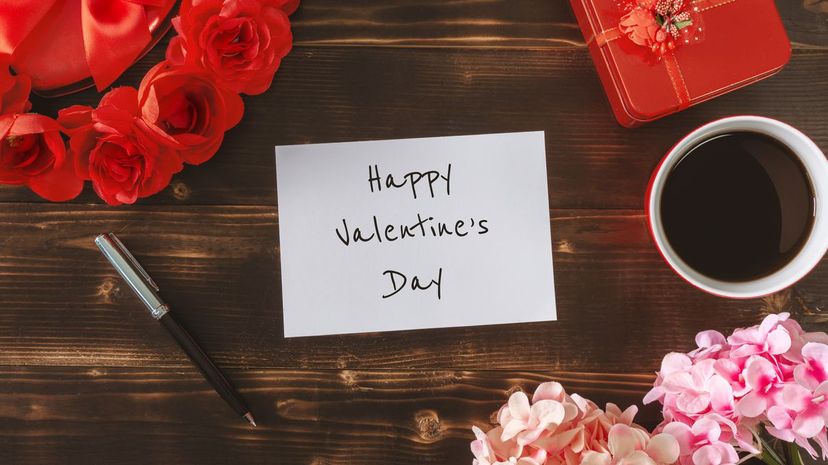 Happy Valentine's Day on White Paper over Rustic Wood Background