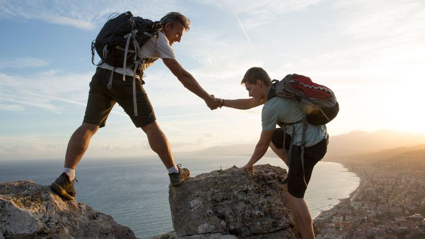 Father helps son to pinnacle summit