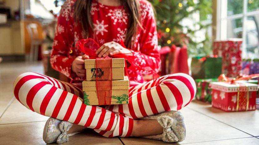 Q25-Cute Young Girl Sitting With Christmas Presents