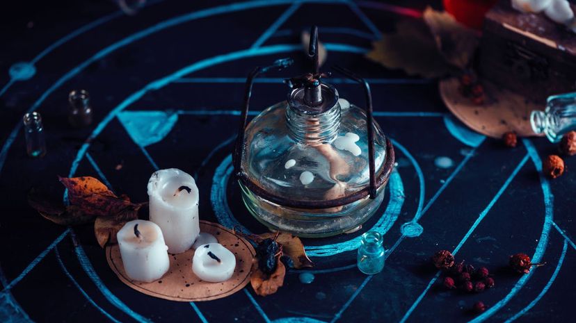 Alchemist workplace with lab burner, candles, and chalk pentagram