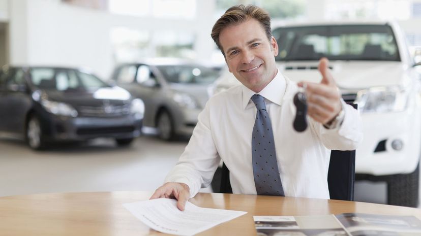 Car Salesman Handing Over Keys