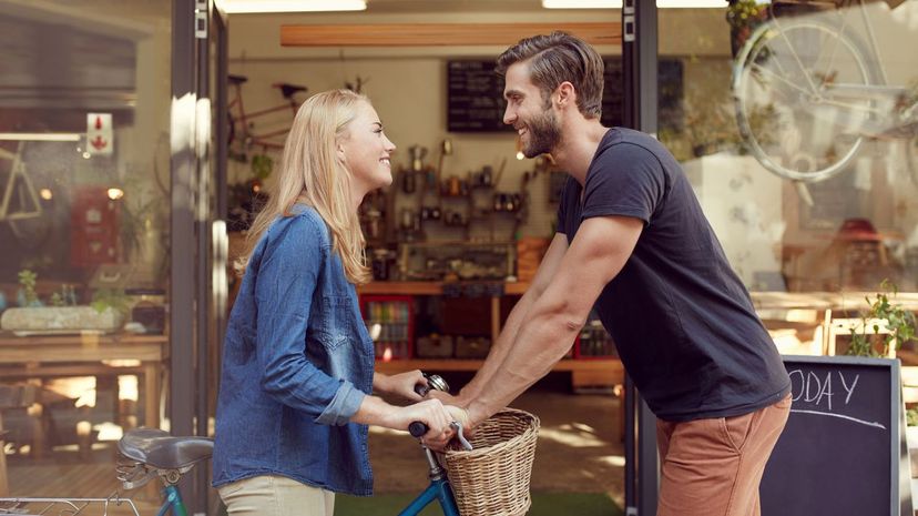 Young couple standing face to face outside of a coffee shop