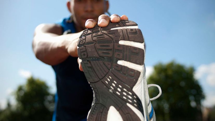 Close up of athlete stretching outdoors