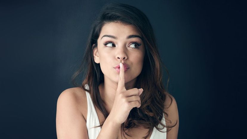 Young woman with finger on lips