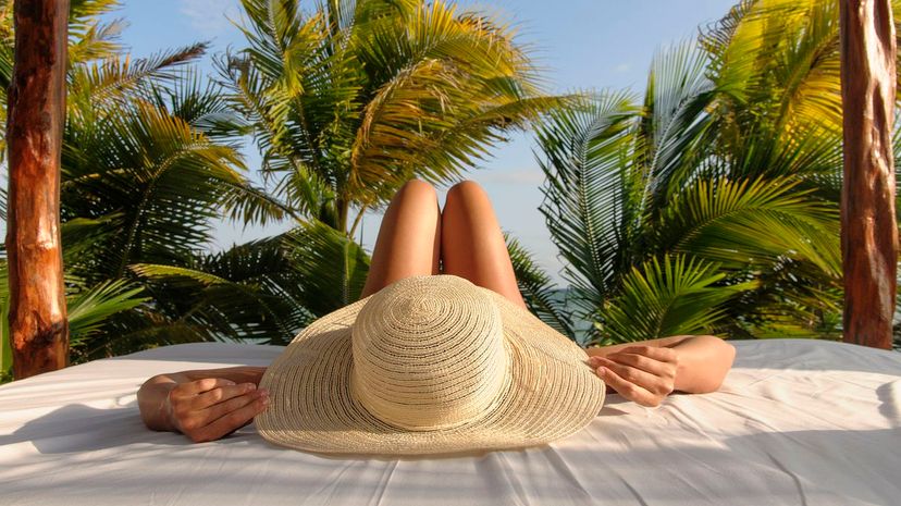 Woman relaxing in hut on beach