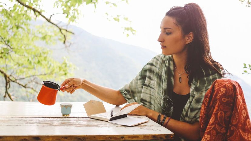 Young woman drinking coffee in the beautiful nature