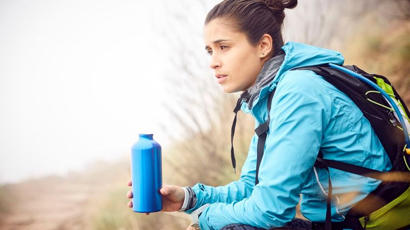 Female traveler holding water bottle