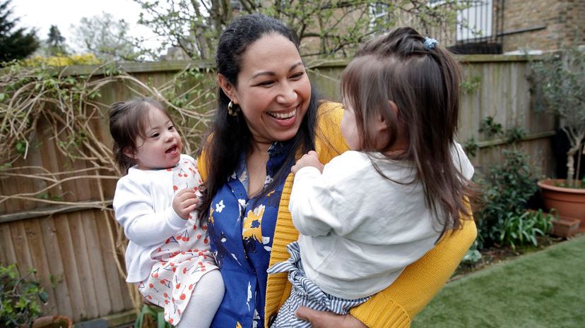 Mother Holding Twin Daughters