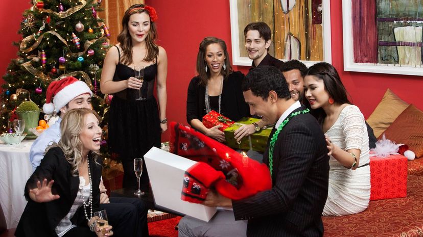 Man opening gift at Christmas party
