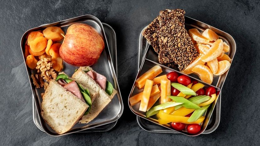 Lunch box with sandwich, vegetables and fruits