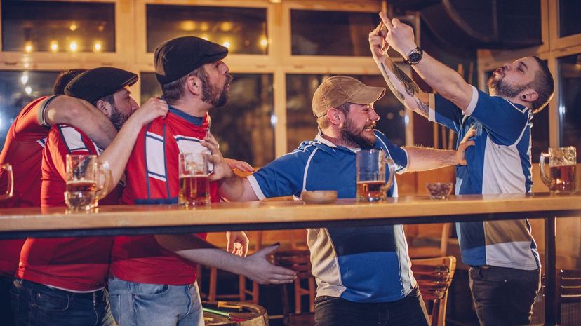 Group of men fighting in bar