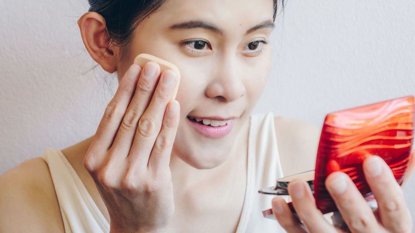 Woman applying foundation