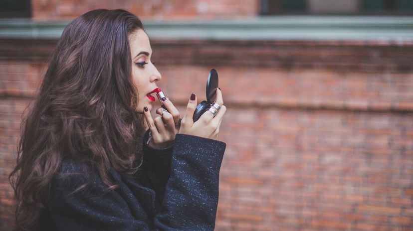 Girl putting lipstick on getting ready