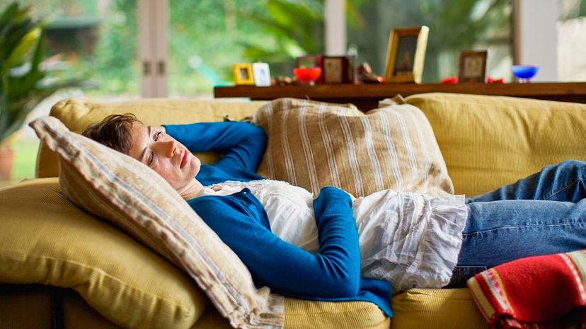 Woman resting on couch at home