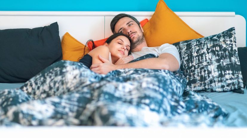 Couple cuddling in bed