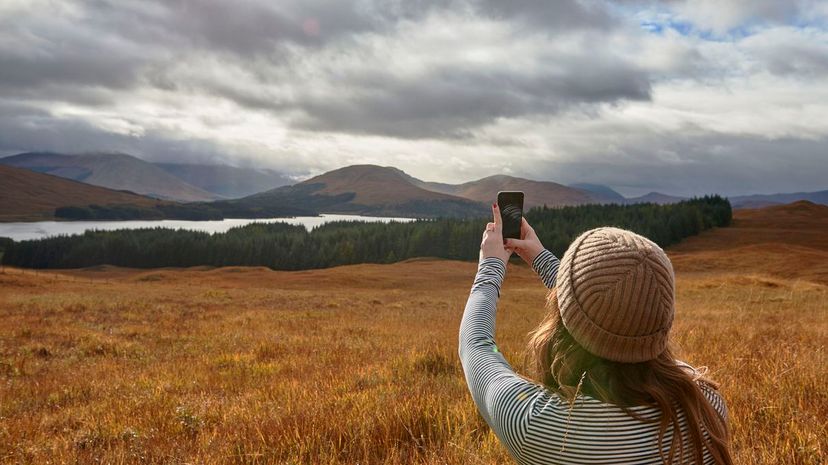 Woman taking landscape photo