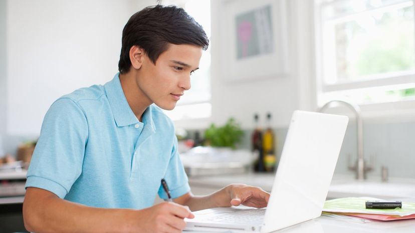 Teenage boy using laptop