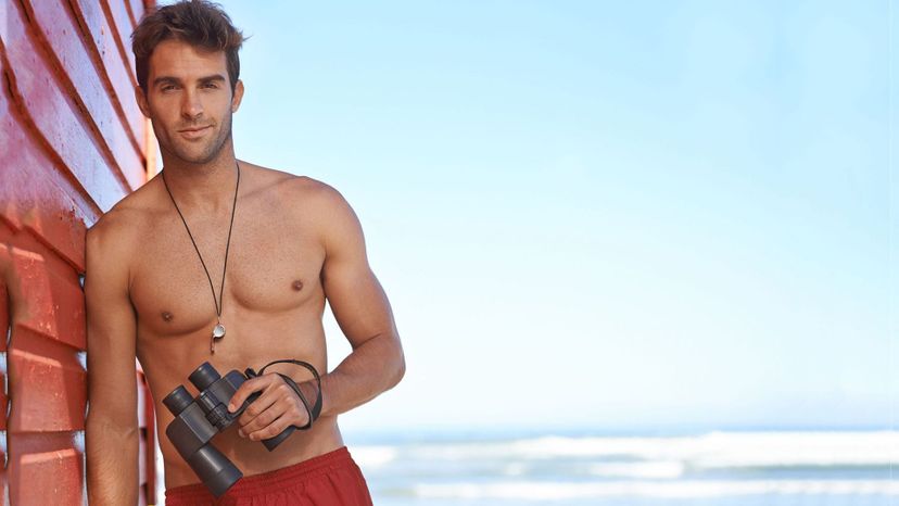 handsome man lifeguard with binoculars