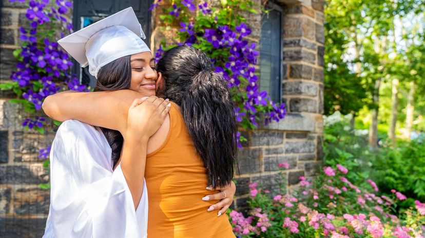 Graduate hugging family