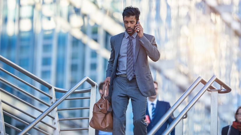 Businessman walking in the city, talking on phone