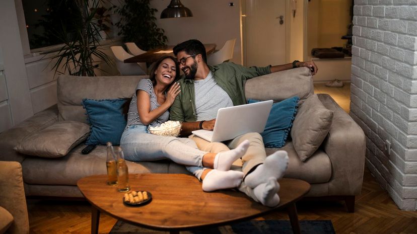 Couple watch movie on couch