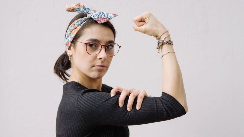 Young woman shows her strong arm