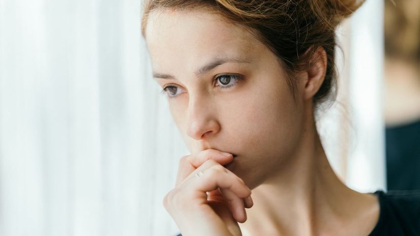 Thoughtful woman looking through the window
