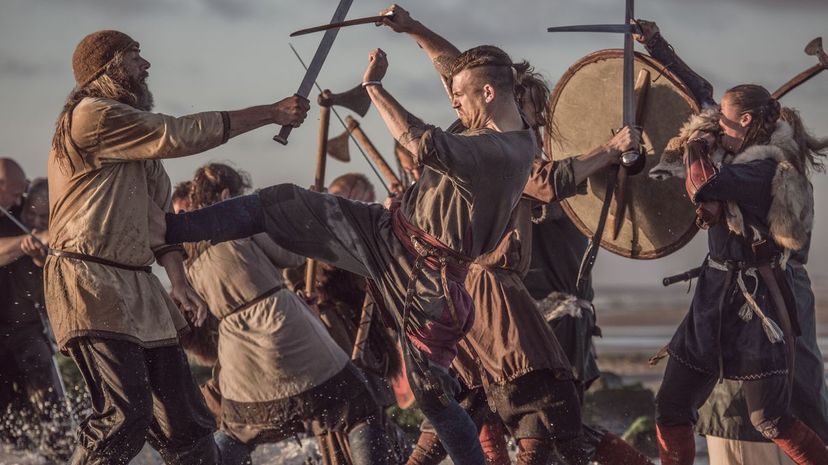 Medieval viking warriors fighting in a battlefield scene in the sea